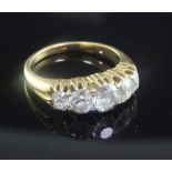 An early 20th century gold and graduated five stone diamond ring, set with old cushion cut stones,