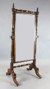 A Regency mahogany cheval mirror, with turned frame and trestle feet, W.2ft 7in. H.5ft 8in.