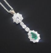 An 18ct white gold, emerald and diamond cluster drop pendant, on a 9ct white gold fine link chain,