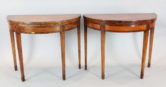 A pair of Sheraton Revival crossbanded satinwood demi-lune card tables, inlaid with shell motifs, on