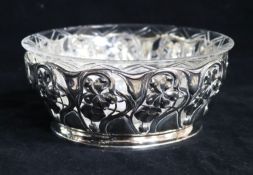 A German Art Nouveau 800 pierced silver bowl with associated glass liner, diameter 17cm, 8 oz.