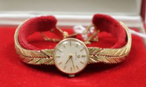 A lady's 9ct gold Omega manual wind wrist watch in box.