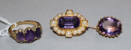 Two Victorian amethyst and gold brooches and a similar three stone ring.