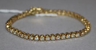 A modern 18ct gold and diamond set tennis bracelet, 16.5cm.