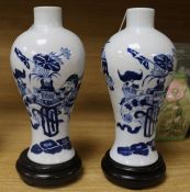 A pair of Chinese blue and white vases, wood stands