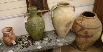 Four assorted terracotta urns, 75cm, 48cm, 46cm and 25cm