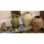 Four assorted terracotta urns, 75cm, 48cm, 46cm and 25cm