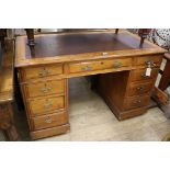 An Edwardian walnut pedestal desk, W.122cm