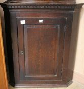 A George III oak hanging corner cupboard, W.81cm