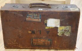 A leather suitcase with labels