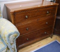 A Regency satinwood banded mahogany chest, fitted three long drawers, flanked by turned pilasters,