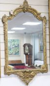 A late 19th century French gilt gesso frame wall mirror, H.110cm