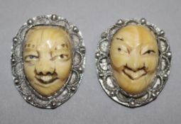 A pair of silver mounted ivory Japanese masks, early 20th century, 3cm.