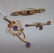 An Art Nouveau 9ct gold amethyst and seed pearl set pendant and two similar brooches.