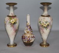 A pair of Doulton Lambeth earthenware floral vases (one broken) and a Carrara ware vase (3)