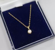 A modern 18ct gold and solitaire diamond pendant, on a 9ct gold chain.