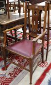 A set of seven Arts & Crafts oak dining chairs, including two carvers