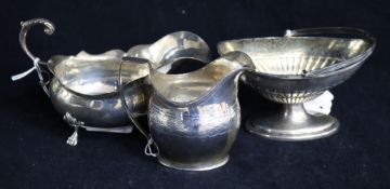 A George III silver cream jug, a late Victorian silver basket and a silver sauceboat. 11.5 oz.