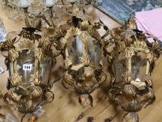 A set of three gilt lanterns