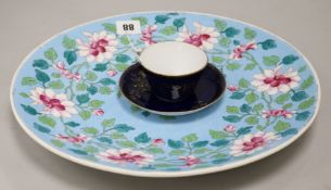 A Gardiner Moscow cup and saucer and a floral charger