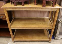 An Edwardian golden oak three tier buffet, W.106cm