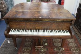 A Schubach figured walnut baby grand piano