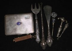 A silver cigarette case and other minor items.