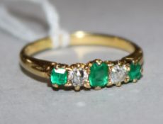 An emerald and diamond five-stone ring, 18ct gold shank, size L.