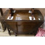 A 1920's carved oak gateleg table, W.105cm