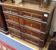 A 17th century style oak chest, fitted four long block fronted drawers W.96cm