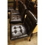 A set of six buttoned leather and oak dining chairs