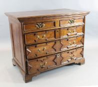 A late 17th century oak chest, of two short and three graduated long drawers, with geometric moulded