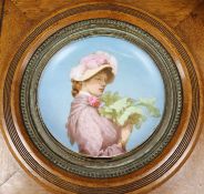 A late 19th century dish painted with a girl, oak frame, 41cm x 42cm