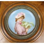 A late 19th century dish painted with a girl, oak frame, 41cm x 42cm