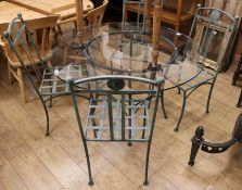 A set of four wrought iron garden chairs with matching glass top table, Diam.122cm