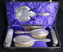 A cased silver dressing table brush set.