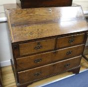 A George III oak bureau, W.102cm