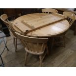 A pine extending dining table and four chairs, W.159cm fully extended with 1 leaf