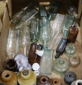 A collection of glass medicine bottles and stoneware bottles