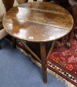 An 18th century oak circular topped two tier cricket table, W.62cm