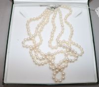 A triple strand cultured pearl necklace with silver clasp.