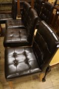A set of six buttoned leather and oak dining chairs