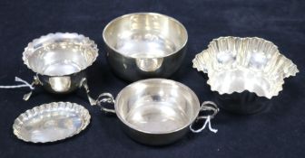 A small silver two-handled bowl, two circular silver bowls, one with waved edge, a fluted silver pin