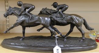 A bronze group of two racehorses