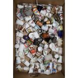 Five thimble display domes and a collection of ceramic, treen and other thimbles, a beaded egg