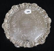 A silver presentation salver with scroll and shell border and scrolled feet, Sheffield 1851, Henry