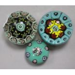 A Paul Ysart millefiori glass paperweight and two other weights possibly by Paul Ysart