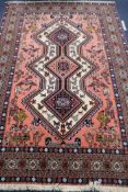 A Persian pink ground rug, 204 x 136cm