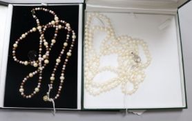 A triple strand cultured pearl necklace with silver clasp. A double row South Sea cultured pearl