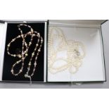 A triple strand cultured pearl necklace with silver clasp. A double row South Sea cultured pearl